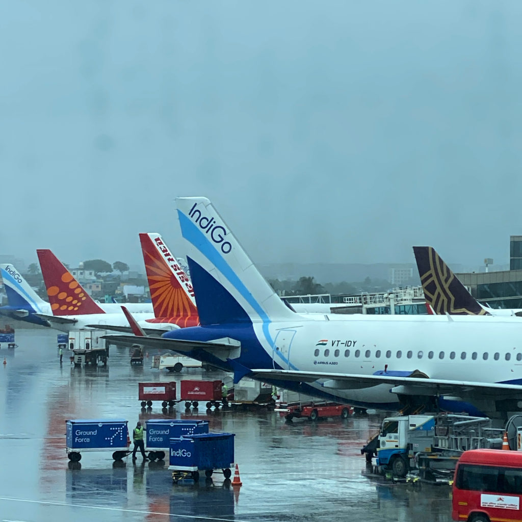 airplanes parked on a wet runway