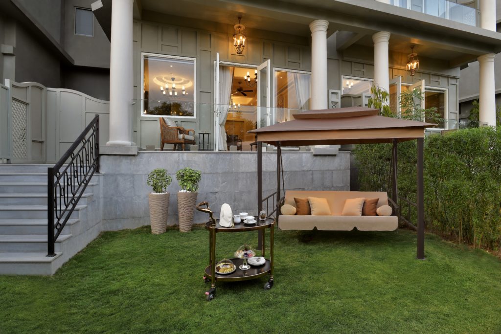a patio with a swing and a table on it