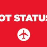 a red sign with white text and a plane
