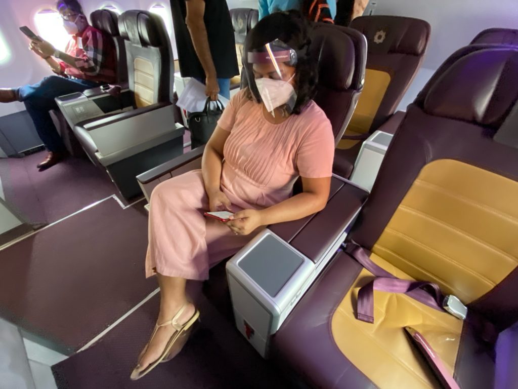 a woman sitting in a chair with a mask on her face