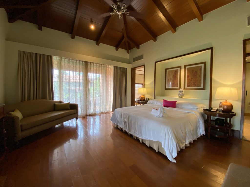 a bedroom with a wood floor and a ceiling fan