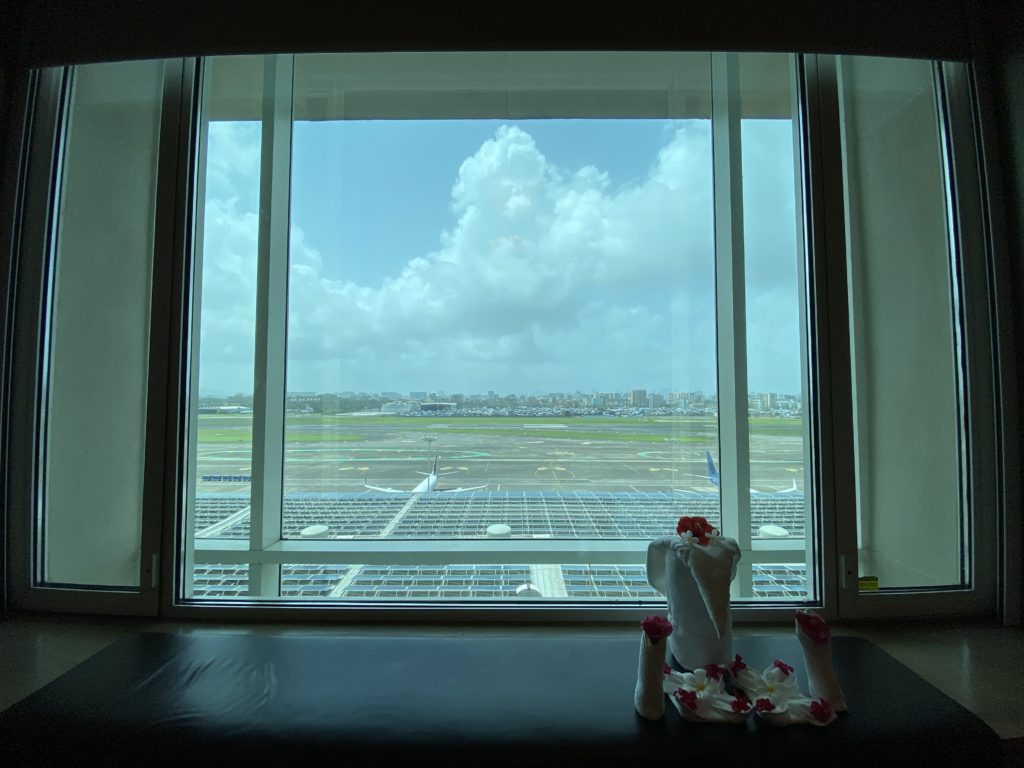 a window with a view of an airport and a city
