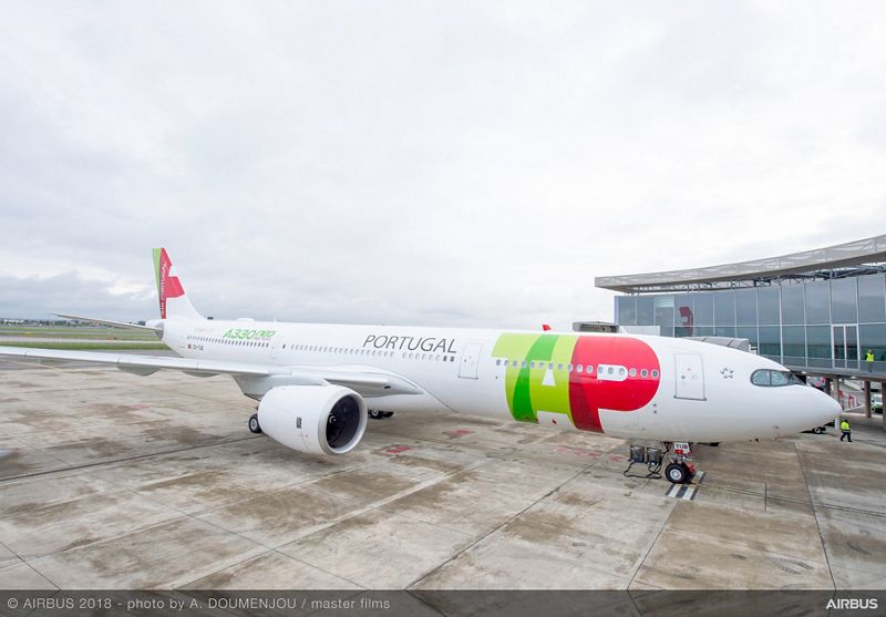 a white airplane with red and green text on it
