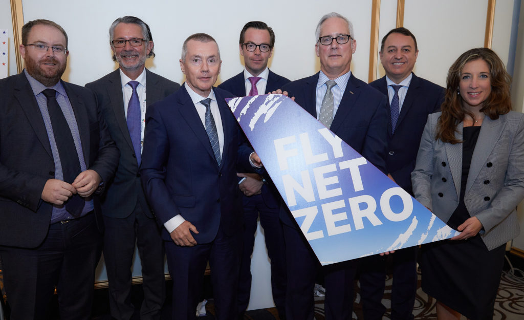 a group of men in suits holding a sign