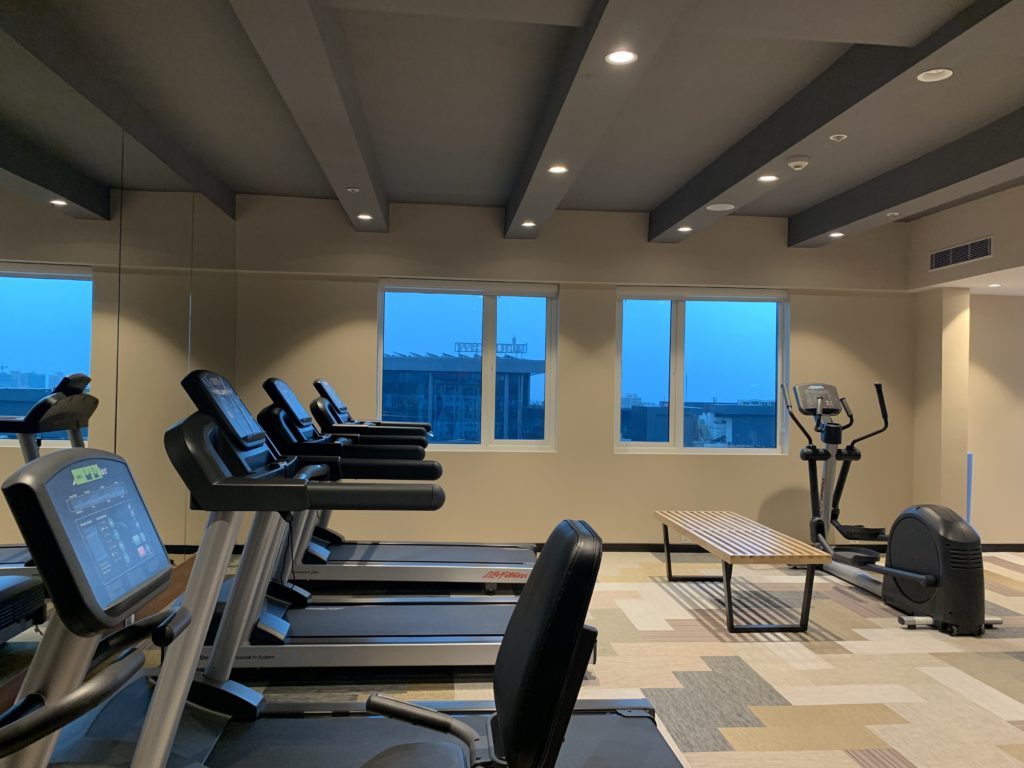 a room with treadmills and a bench