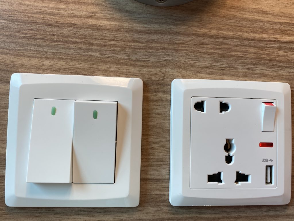a white switches on a wood surface