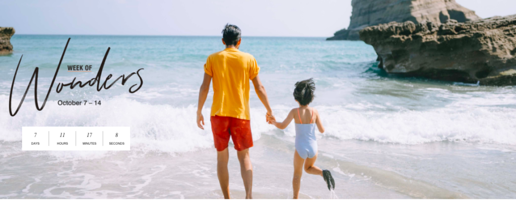 a man and child holding hands on a beach