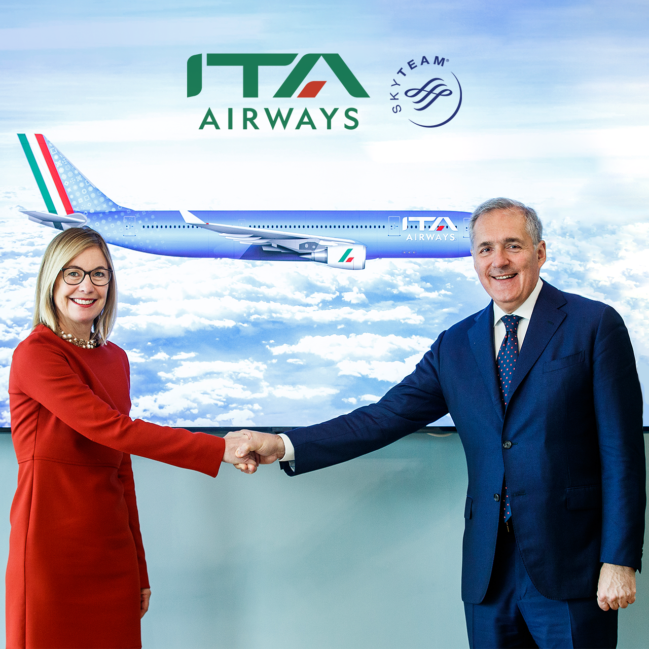 a man and woman shaking hands in front of a wall with an airplane