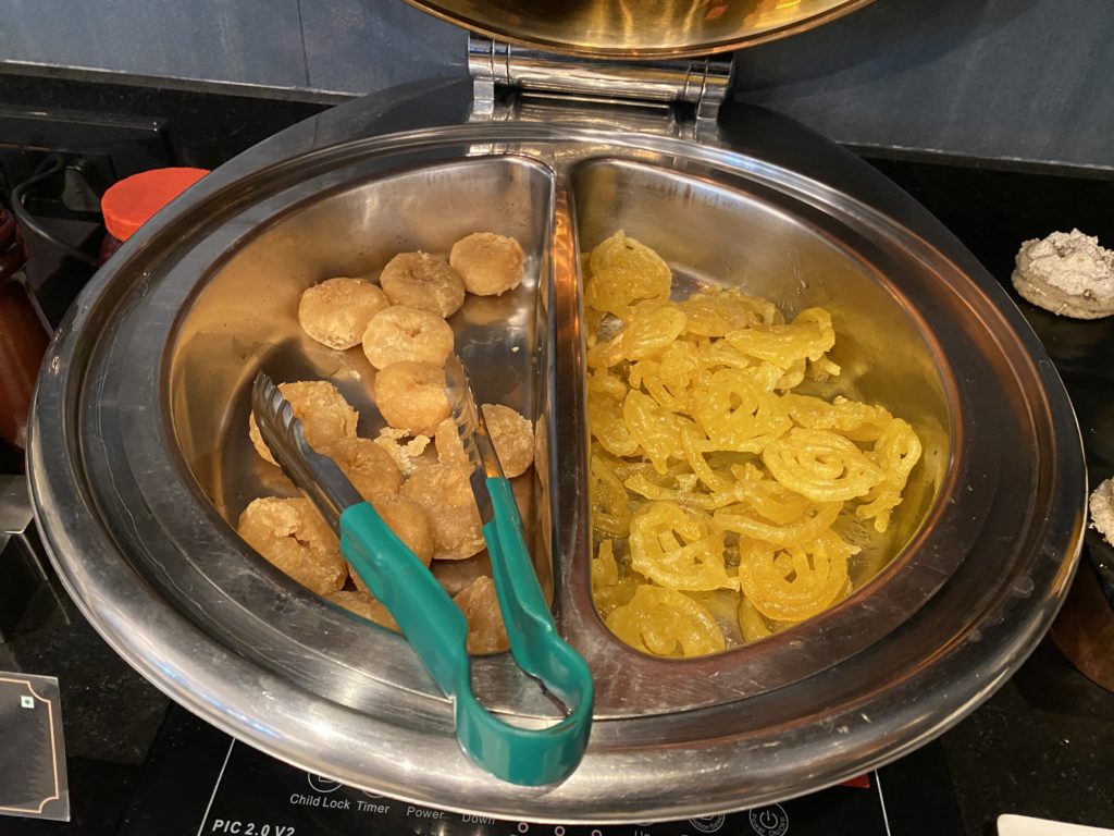 a bowl of food with tongs