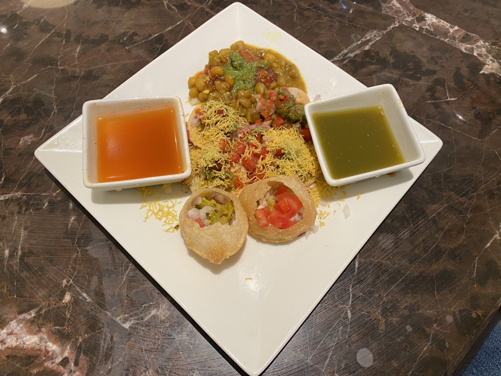 a plate of food on a marble surface