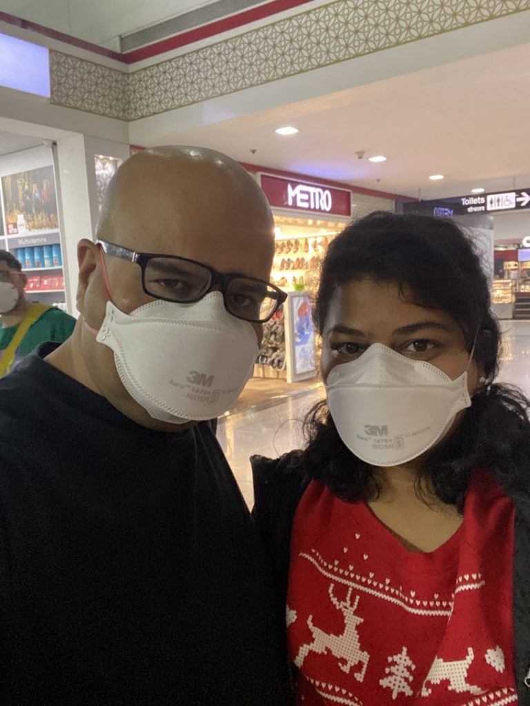 a man and woman wearing face masks