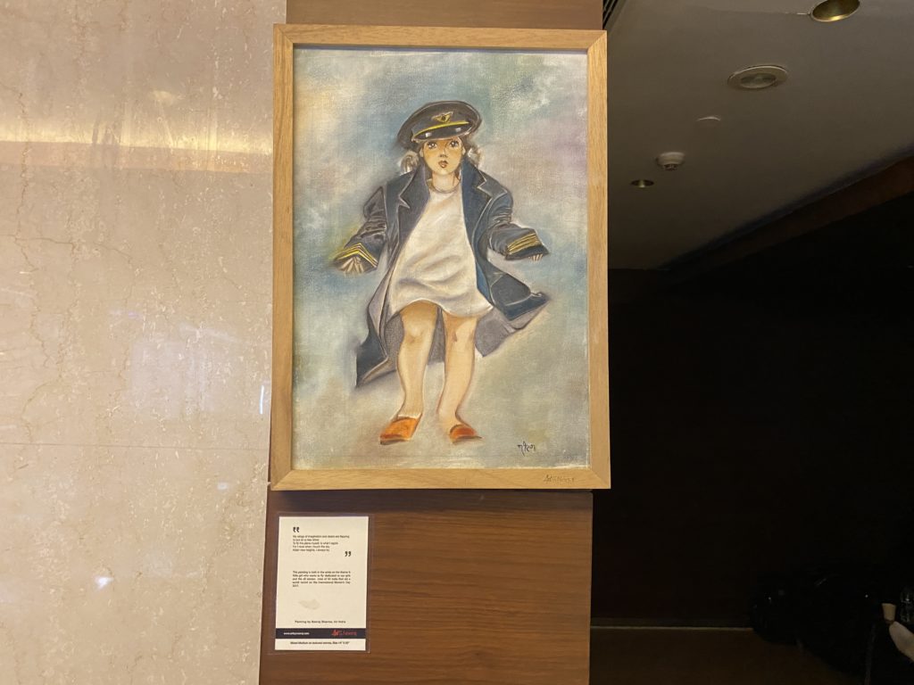 a framed picture of a girl in a hat