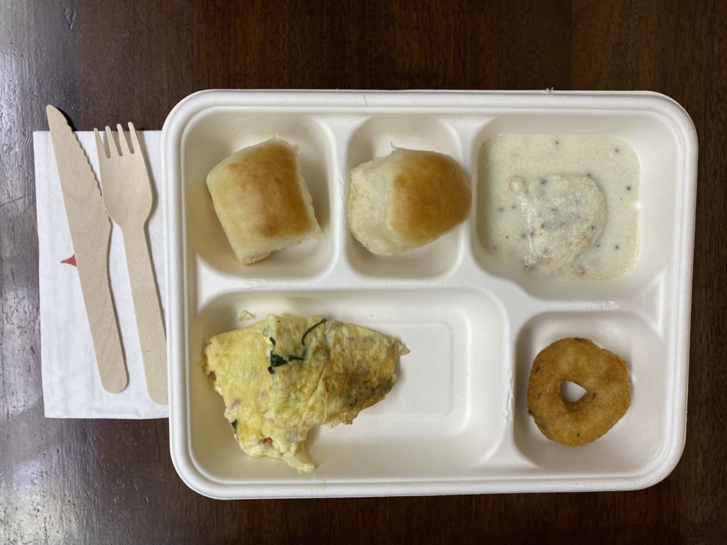 a white styrofoam tray with food on it