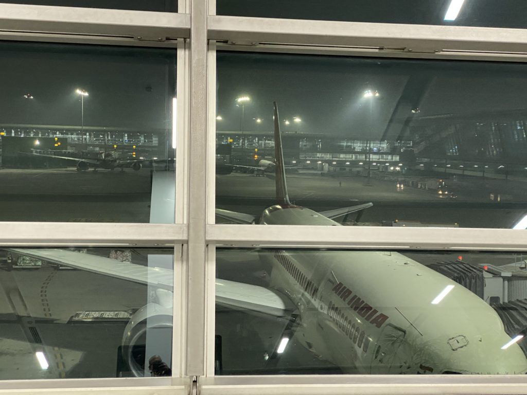 a window of an airport with a plane