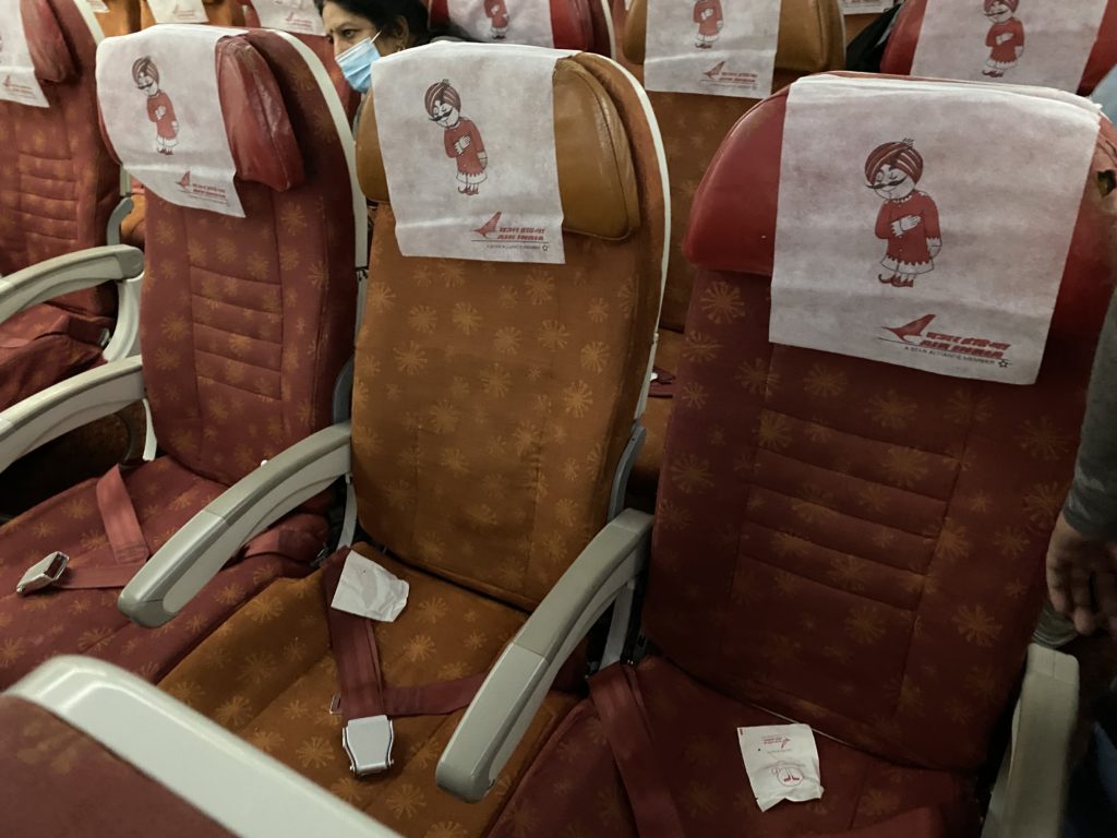 a group of seats with a person wearing a mask