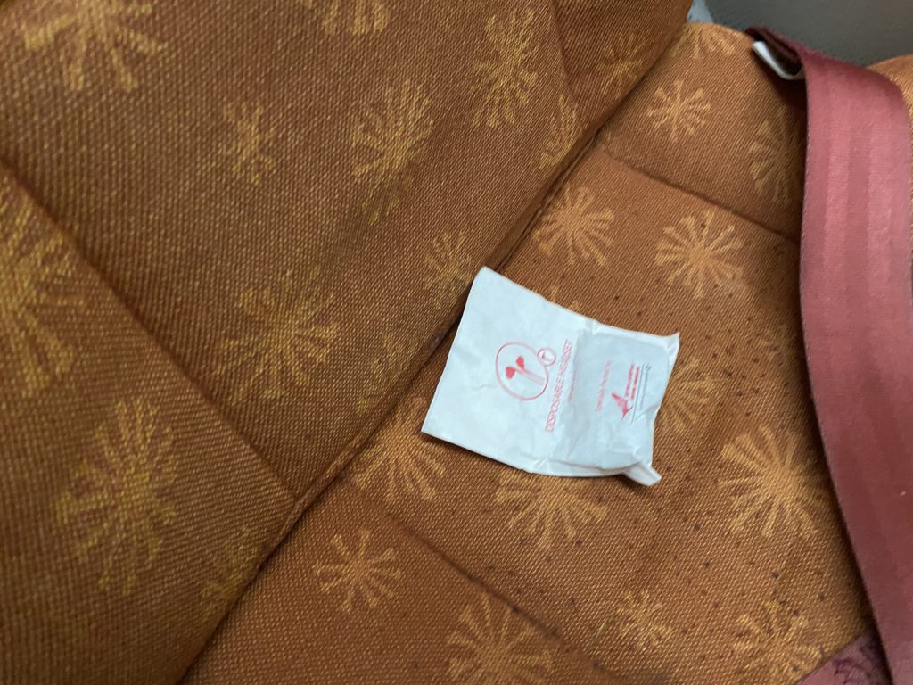 a white packet on a brown seat