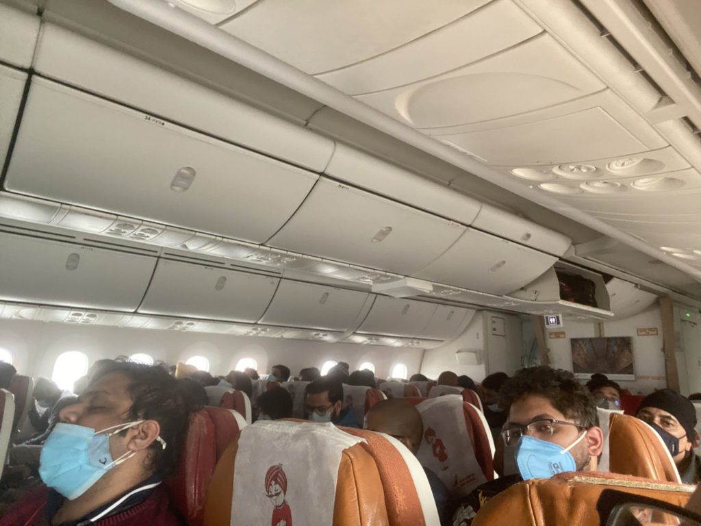 people wearing masks on an airplane