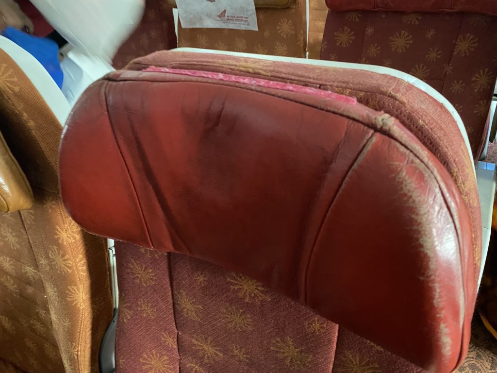 a red leather chair with a brown backrest