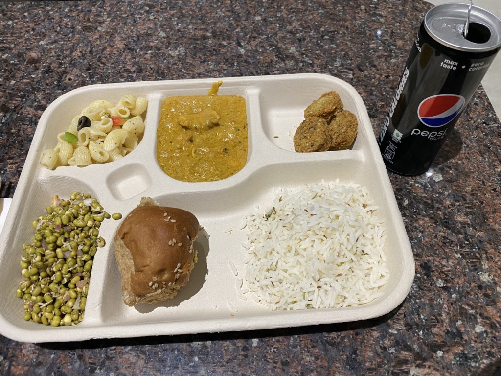 a tray of food and a soda can