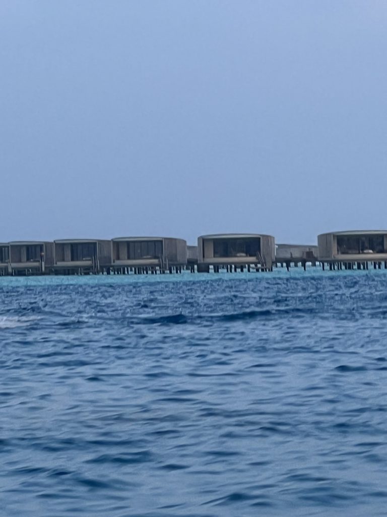 a row of buildings on stilts in the water