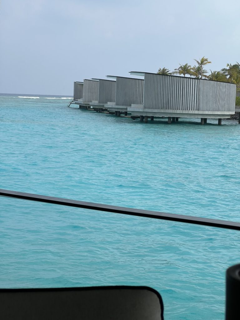 a row of buildings on stilts in the water