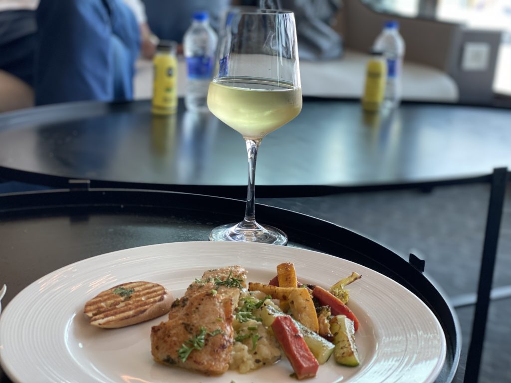a plate of food and a glass of wine