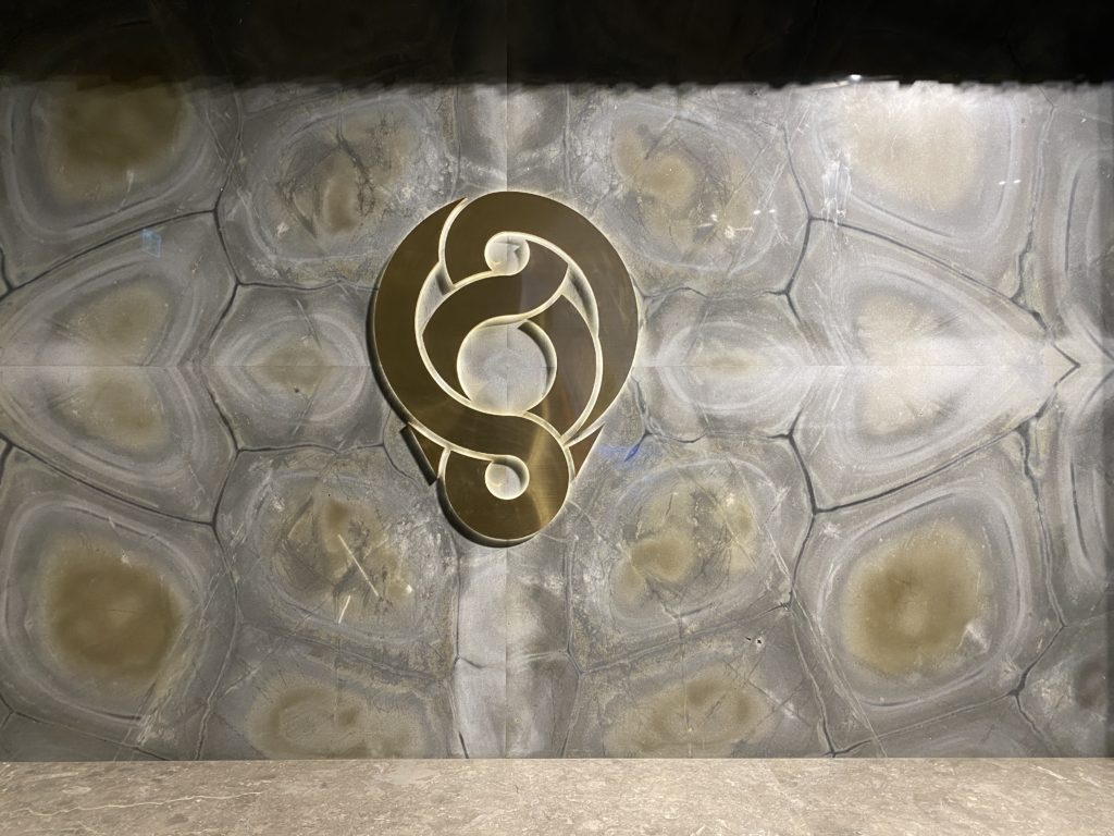 a gold logo on a marble surface