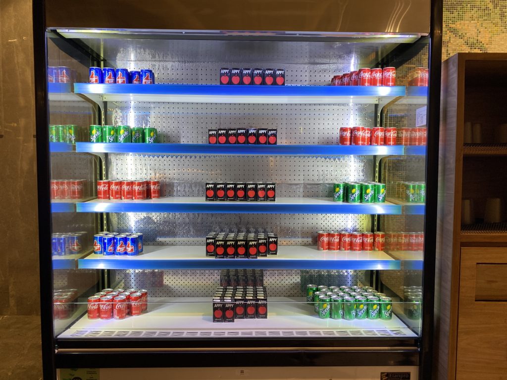 a display case with several cans of soda