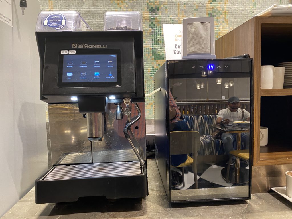 two coffee machines with a mirror on the side
