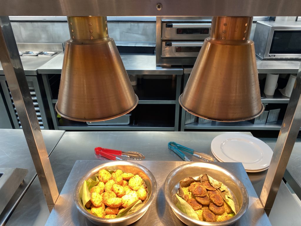 a metal bowls with food in it