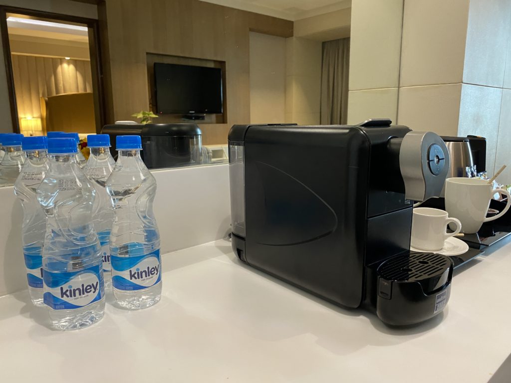 a machine and bottles of water on a counter