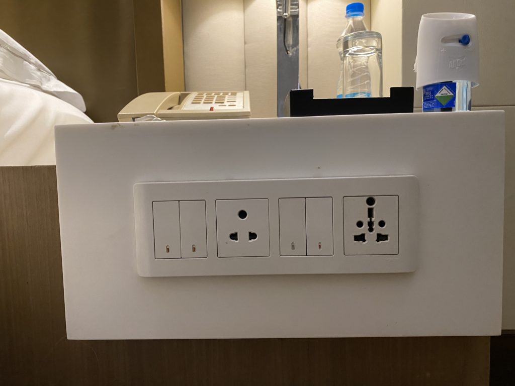 a white rectangular object with electrical outlets on a table