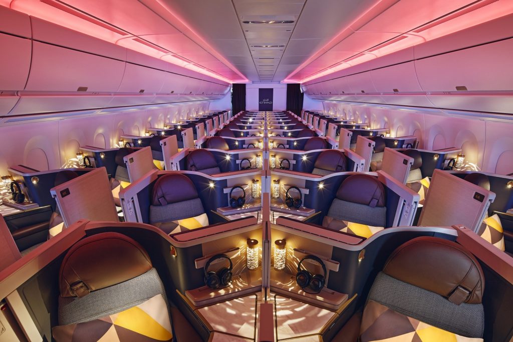 a room with rows of seats and a pink light