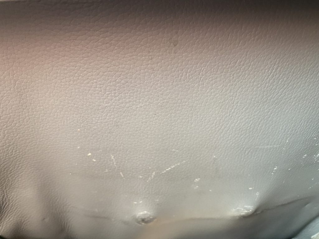 a close up of a white leather surface
