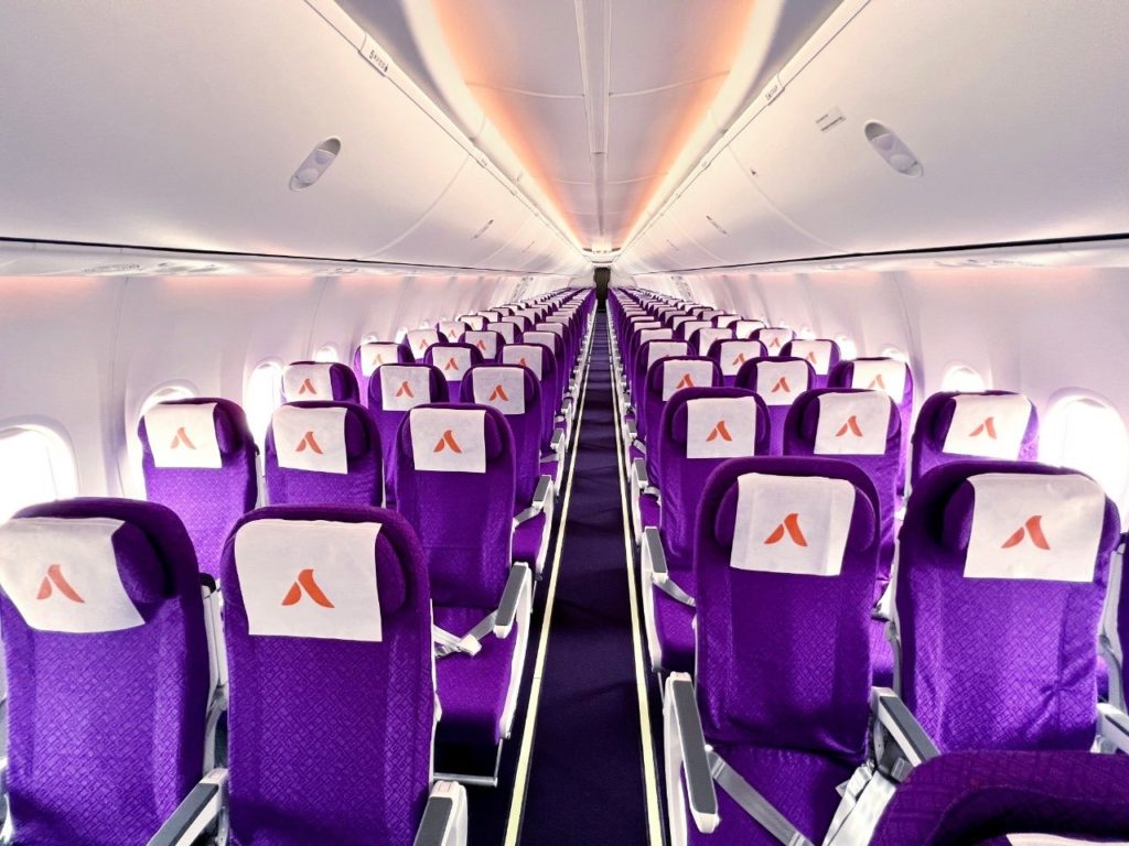 rows of purple seats with orange logo on them