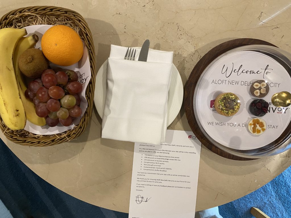 a plate of fruit and a napkin on a table