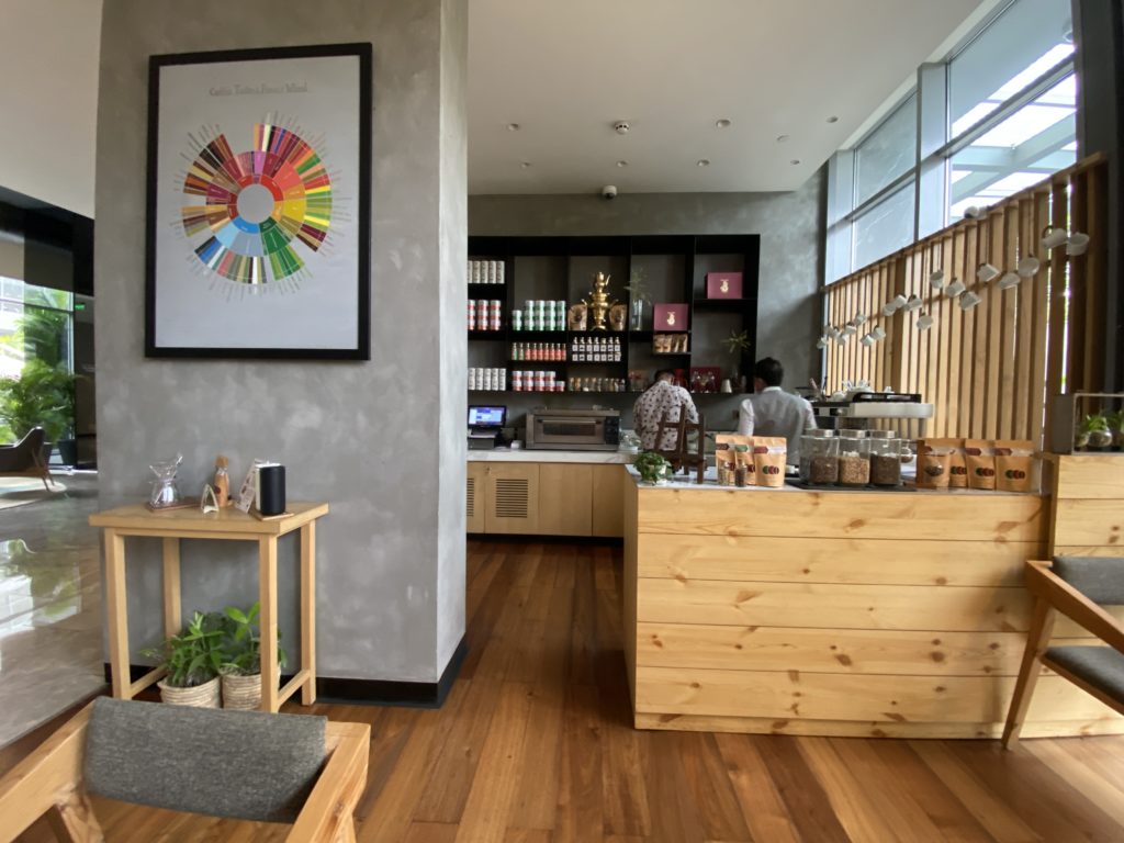 a coffee shop with a counter and a couple of people behind it