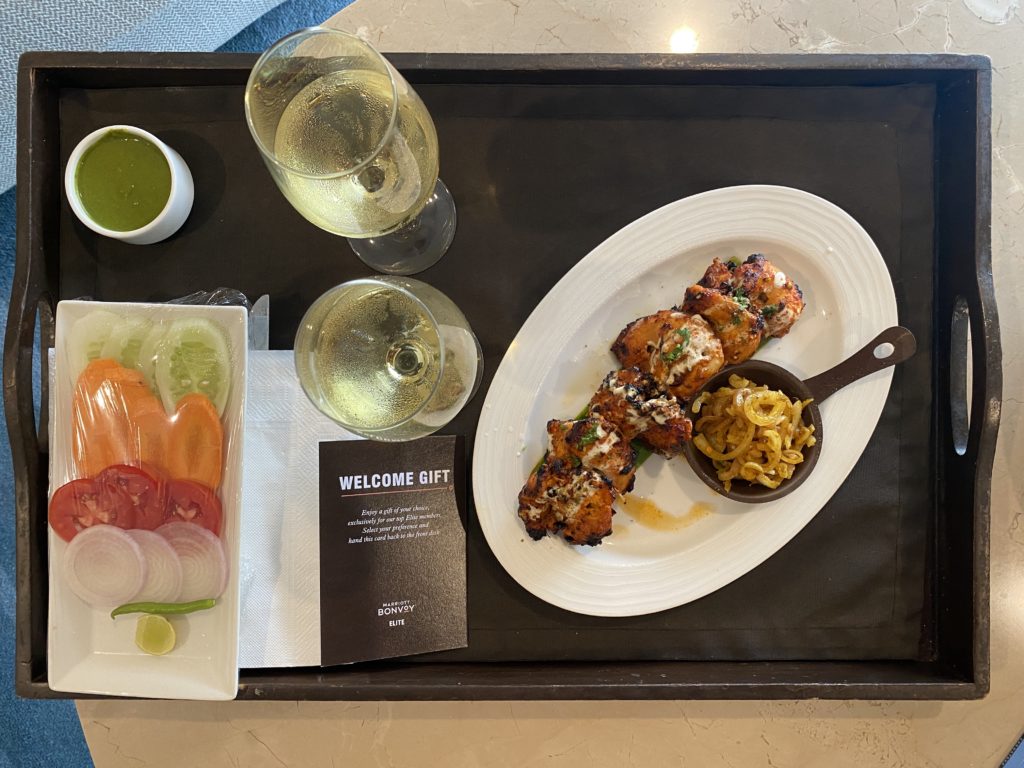 a plate of food and wine glasses on a tray