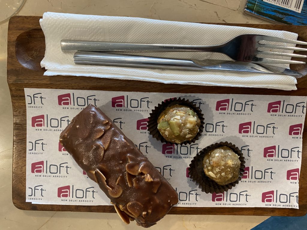 a chocolate bar and two chocolate candies on a napkin and fork