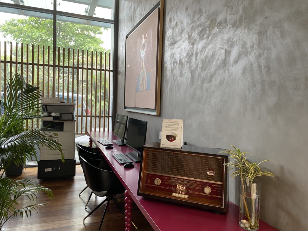 a desk with computers and a radio on it