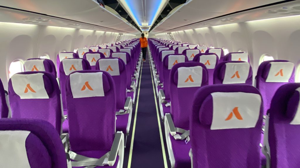 a row of purple seats with orange logo on them