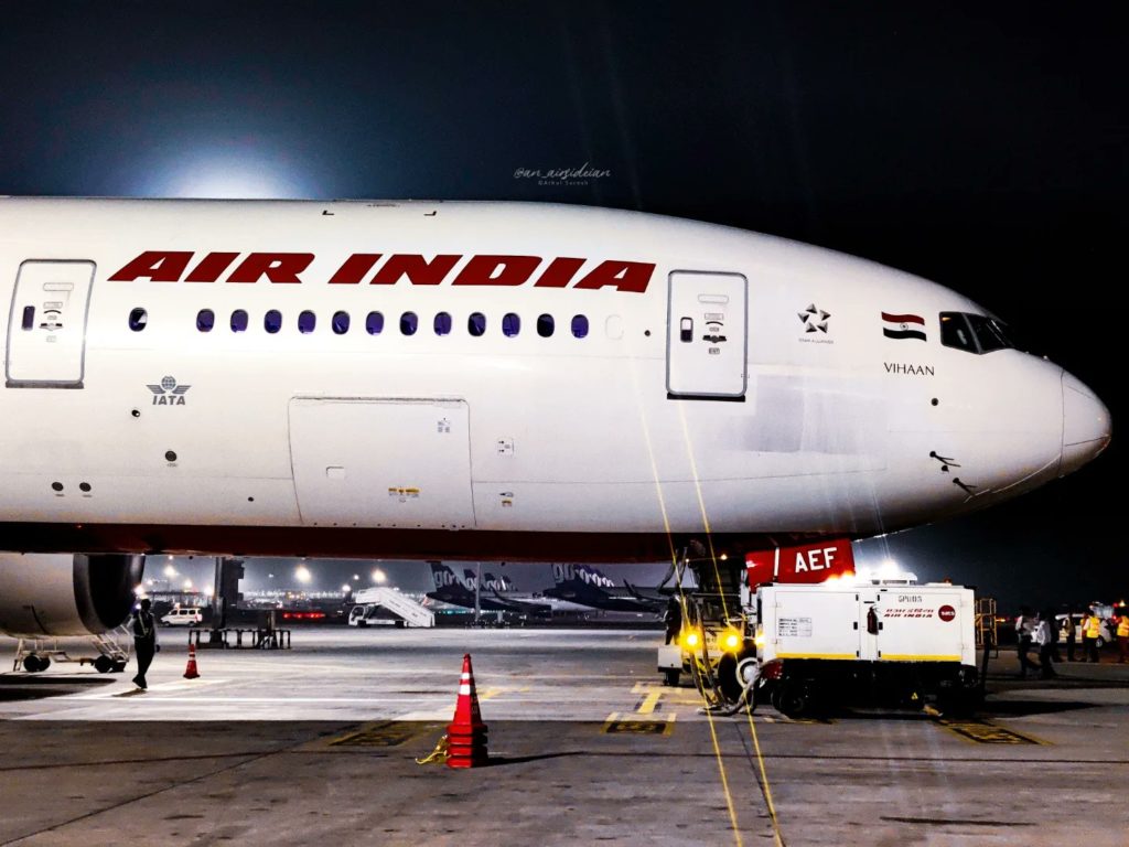 a large white airplane with red writing on it