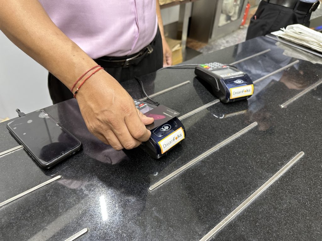 a person holding a credit card reader