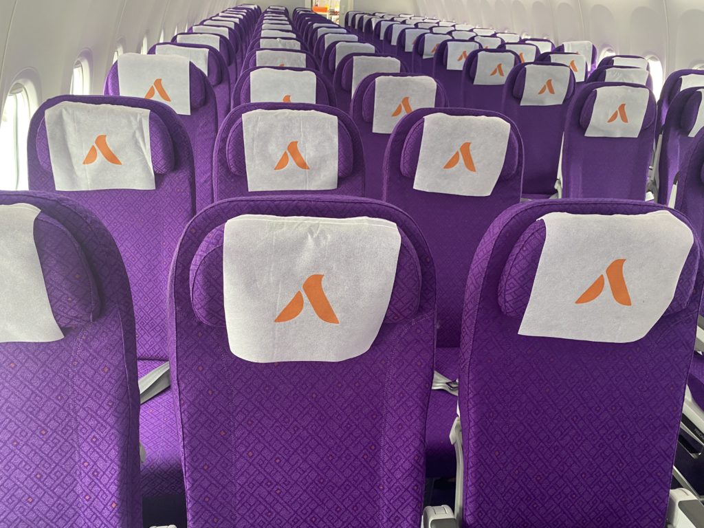 a row of purple seats with white towels on them