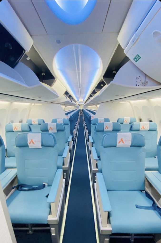 a row of blue seats in an airplane