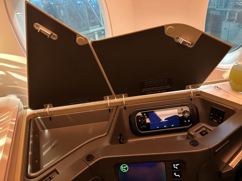 an airplane seat with a screen and a screen