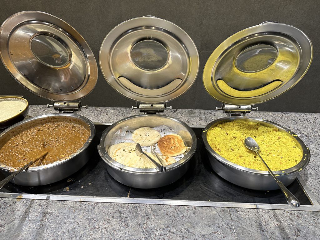 a group of metal containers with food in them