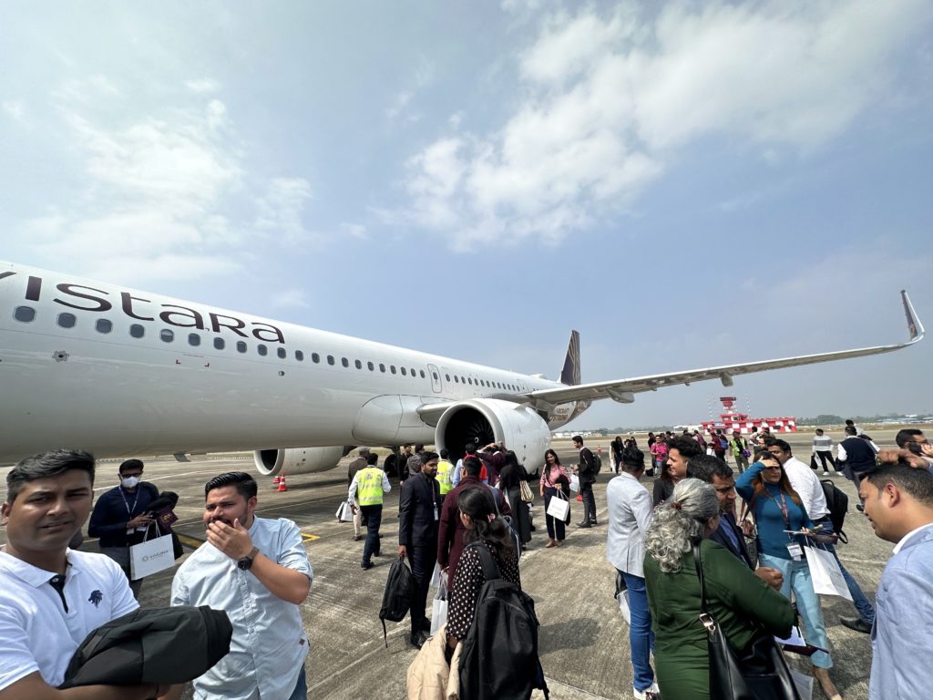 a group of people standing around an airplane