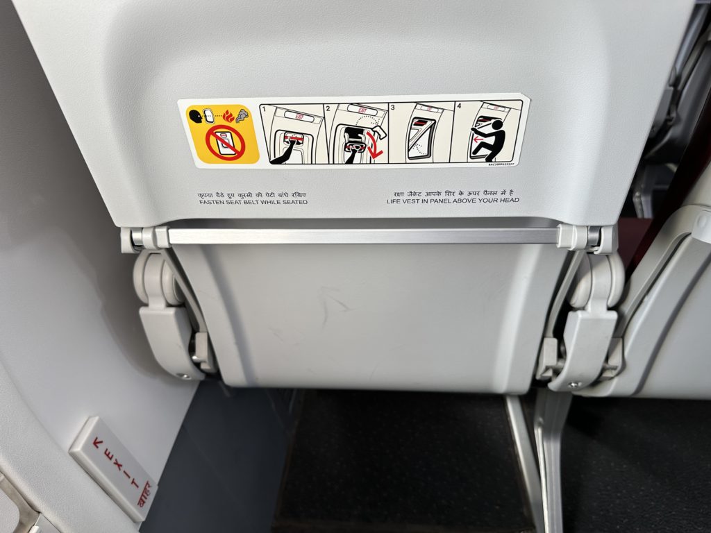 a white seat with a sign on it