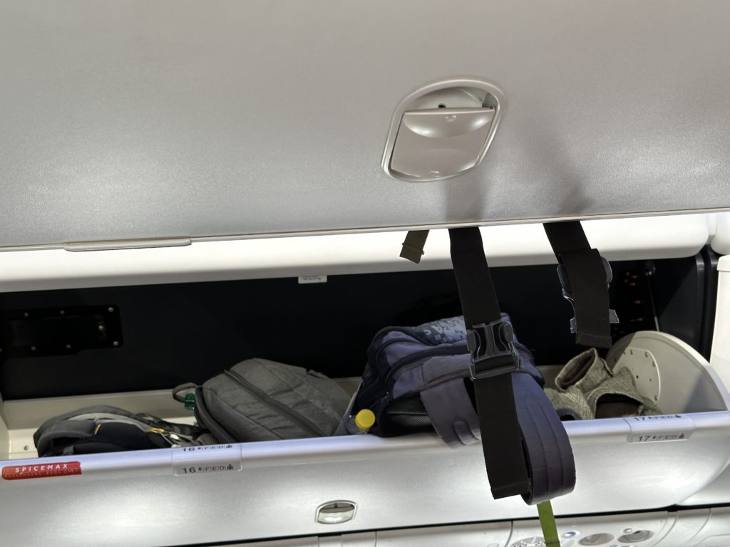 a shelf with luggage and backpacks on it